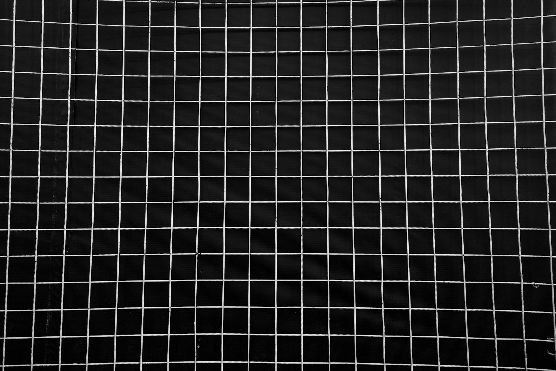 Abstract dark geometric grid lines on deep charcoal